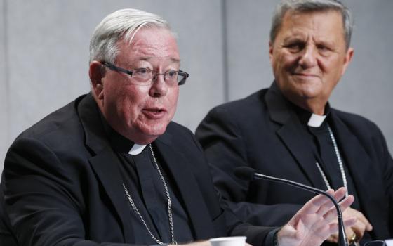 Cardinal Jean-Claude Hollerich of Luxembourg, relator general of the Synod of Bishops, speaks at a news conference to present an update on the synod process, at the Vatican in this Aug. 26, 2022, file photo. Looking on is Cardinal Mario Grech, secretary-general of the synod. (CNS/Paul Haring)