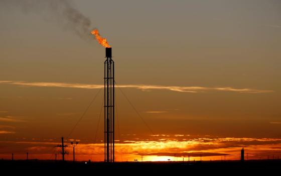 A flare burns excess natural gas in the Permian Basin in Loving County, Texas, in this Nov. 23, 2019, file photo. (CNS/Reuters/Angus Mordant)