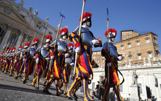 Two lines of men with striped pants and plumed hats walk in lines