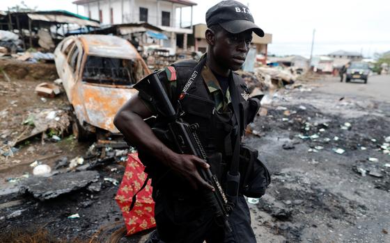 A Cameroonian elite Rapid Intervention Battalion member patrols the abandoned village of Ekona Oct. 4, 2018, in the Anglophone region of Cameroon. (CNS/Reuters/Zohra Bensemra)