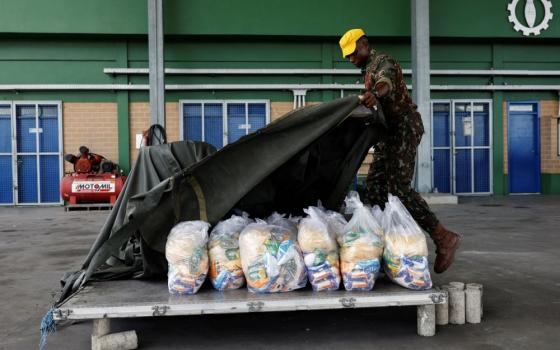 A member of the Brazilian Air Force prepares a platform loaded with food bags to be launched to the Surucucu base at Yanomami indigenous territory in Boa Vista, Brazil, Feb. 2, 2023. (OSV News/Reuters/Amanda Perobelli)