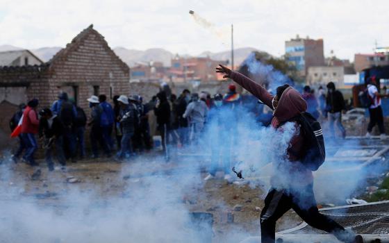 Demonstrators clash with security forces near the Juliaca, Peru, airport during a Jan. 9, 2023, protest demanding early elections and the release of jailed former Peruvian President Pedro Castillo. (OSV News/Reuters/Hugo Courotto)