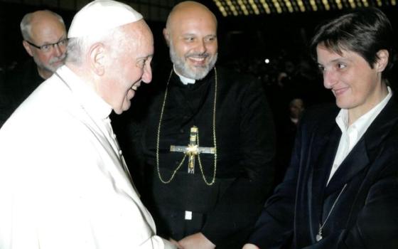 Nadia Coppa shakes hands with Pope Francis.