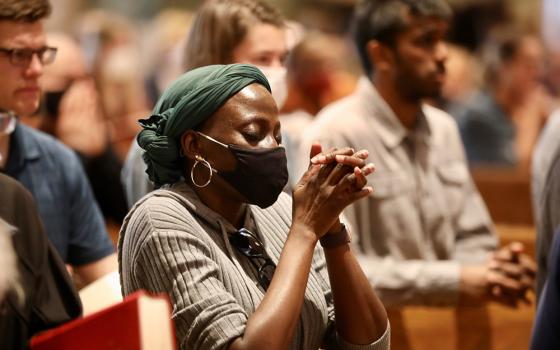 People in Washington pray at the Cathedral of St. Matthew the Apostle on Good Friday, April 15, 2022, during the celebration of the Liturgy of the Lord's Passion. (CNS/Catholic Standard/Andrew Biraj)