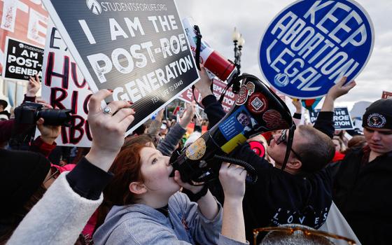 Supporters of legal abortion and pro-life demonstrators hold signs outside the U.S. Supreme Court during the annual March for Life Jan. 20, 2023, in Washington, for the first time since the U.S. Supreme Court overturned the Roe v. Wade abortion decision. (OSV News/Reuters/Jonathan Ernst)