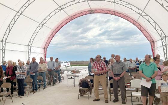 Worshippers pray in the hoop barn on the Pieper family farm in Donnellson, Iowa, during a Mass for the farm and the blessing of seeds April 15, 2023. Father Dan Dorau celebrated the Mass, whose inspiration comes from Catholic Rural Life. The four parishes he leads in Lee and Van Buren counties collaborated. (OSV News/The Catholic Messenger/Barb Arland-Fye)