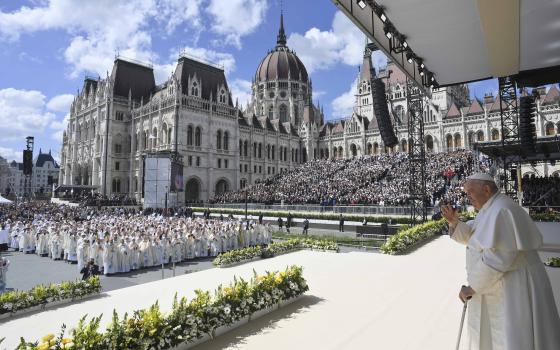 Pope Francis waves after celebrating Mass with about 50,000 people in Budapest's Kossuth Lajos Square, with the Hungarian Parliament building in the background, April 30, 2023. (CNS photo/Vatican Media)