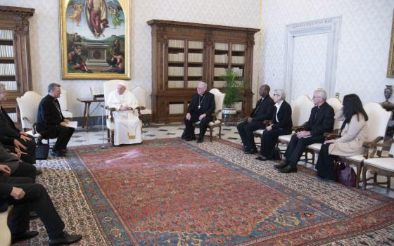 Pope Francis meets with members of the preparatory commission for the general assembly of the Synod of Bishops in the library of the Apostolic Palace at the Vatican March 16. Pictured to the right of the pope are: Cardinal Jean-Claude Hollerich of Luxembourg, general relator of the upcoming synod; Bishop Lucio Muandula of Xai-Xai, Mozambique; Mercedarian Sister Shizue "Filo" Hirota from Tokyo; Archbishop Timothy Costelloe of Perth, president of the Australian bishops' conference; and a synod staff member. (