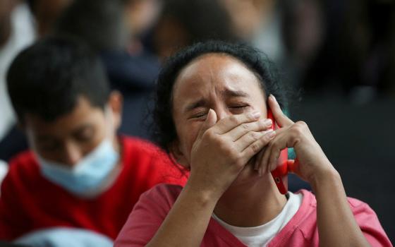 A Colombian migrant woman reacts at the El Dorado International Airport in Bogota, Colombia, May 11, 2023, after being deported from the United States, as the U.S. prepares to lift the COVID-19 era restrictions known as Title 42.