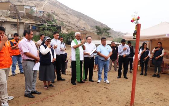 Archbishop Miguel Cabrejos Vidarte of Trujillo, Peru, visits a settlement in La Esperanza district, in Trujillo, on June 5, 2023, and donates two houses to residents who lost their homes during the floods that hit northern Peru in March. The rains and floods helped to propagate the dengue virus epidemic in the country, which resulted in at least 248 deaths and 146,000 cases. (OSV News Photo/courtesy Trujillo Archdiocese)