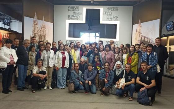 A group of students, teachers and employees of the Institute of Theological Sciences of the Immaculate Virgin Mary in Horodok, Ukraine stand in the Martyrs Memorial in the city of Tyvriv. (Courtesy of Iryna Saszko)