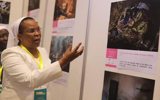 During a July 18 side event of the Women Deliver 2023 Conference in Kigali, Rwanda, Sr. Jane Wakahiu explains an image in which a woman is breastfeeding a newborn baby lying on the floor. Wakahiu, of the Institute of the Little Sisters of St. Francis, also highlighted some of the challenges women in poverty experience. (GSR photo/Doreen Ajiambo)