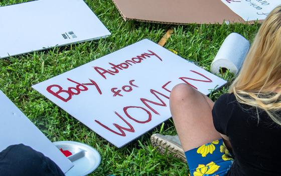 Young activists prepare placards for a demonstration in Lakeland, Florida, on June 30, 2022, protesting the U.S. Supreme Court's June 24 ruling in Dobbs v. Jackson Women's Health Organization, which overturned Roe v. Wade's protection of abortion rights. (Dreamstime/Marcello Sgarlato)