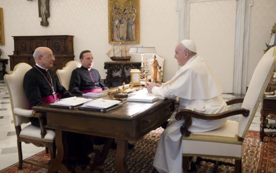 Pope Francis meets Msgr. Fernando Ocáriz, left, the prelate of Opus Dei, and Msgr. Mariano Fazio, the auxiliary vicar of the prelature, during an audience at the Vatican Nov. 29, 2021. (CNS photo/Vatican Media)