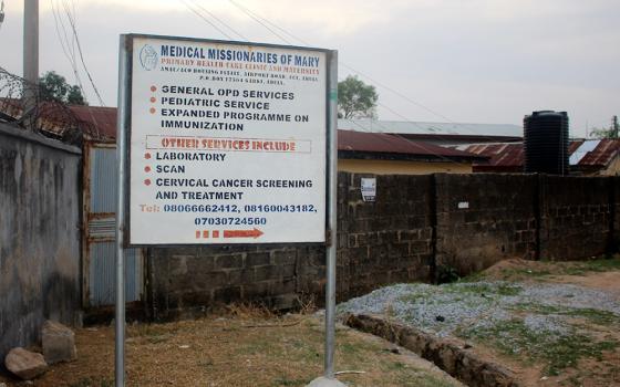 A signpost near the clinic's entrance informs the public about the Medical Missionaries of Mary's health care services in Lugbe, Abuja, Nigeria. (GSR photo/Valentine Benjamin)