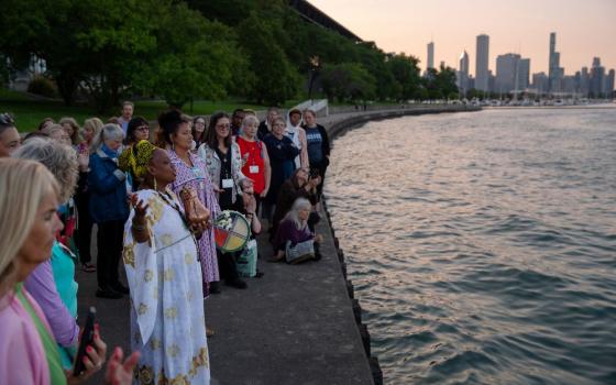 Yoruba priestess Aina-Nia leads a water ceremony by Lake Michigan as part of the Parliament of the World’s Religions in Chicago on Aug. 15, 2023. 