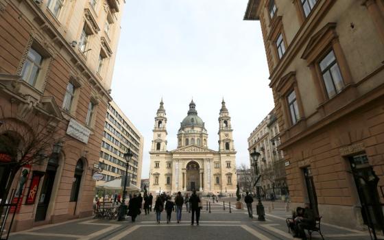 Pedestrians walk toward St. Stephen's Basilica in Budapest, Hungary.