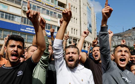 Palestinians take part in a protest in Nablus, West Bank, Oct. 18 in support of the people in Gaza, after hundreds of Palestinians were killed the previous day following an airstrike on the CNEWA-supported al-Ahli Arab Hospital in Gaza City. (OSV News/Reuters/Raneen Sawafta)