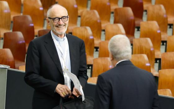 Cardinal Michael Czerny, prefect of the Dicastery for Promoting Integral Human Development, arrives in the Vatican's Paul VI Audience Hall for a working session of the assembly of the Synod of Bishops Oct. 20. (CNS/Lola Gomez)