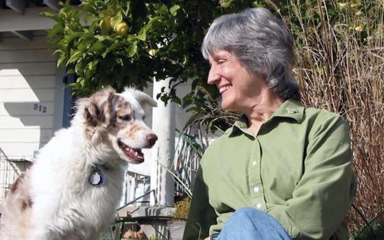 Donna Haraway and her dog, Cayenne, are pictured at home in 2007. The phrase "contact zone," cited by Pope Francis in Laudate Deum, is from a chapter in Haraway's 2008 book When Species Meet that explores their experience training Cayenne in agility, a sport where a dog and a human handler navigate an obstacle course. (Rusten Hogness)