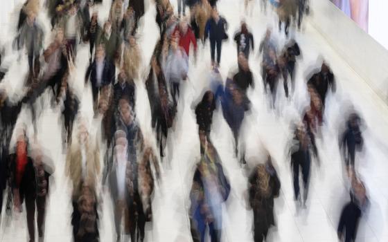 Commuters walk along a corridor in the World Trade Center in New York on Nov. 18, 2019. Thirty percent of Americans don't identify with a religious group — but not all of them are atheists or agnostics. In fact, 43% of the group known as the "nones" say they believe in God, even if they largely dislike organized religion. (AP/Mark Lennihan, File)