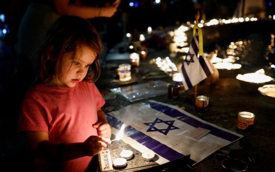 A girl lights a candle