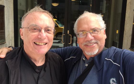 Daryl Grigsby, at right, is pictured with Fr. Paul Magnano, the priest who confirmed him in 1998. (Courtesy of Daryl Grigsby)