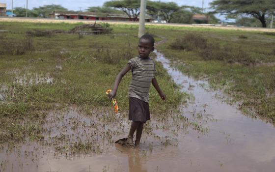 A child walking through the flooded water in Samburu, northern Kenya, on Nov. 9. (GSR photo/Doreen Ajiambo)