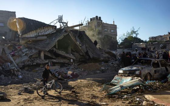 Palestinians search for bodies and survivors in the rubble of a residential building destroyed in an Israeli airstrike, in Rafah, southern Gaza Strip, on Dec. 15. (AP/Fatima Shbair)