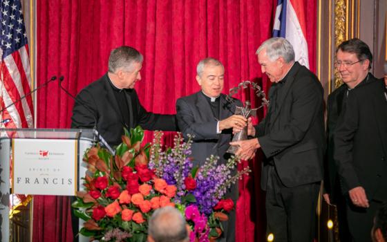 Father Jack Wall, president of Catholic Extension, presents Archbishop Roberto Gonzalez Nieves of San Juan, Puerto Rico, center, with Catholic Extension’s 2023 Spirit of Francis Award in New York City Nov. 28. Also pictured are Cardinals Blase J. Cupich of Chicago, left, and Christophe Pierre, nuncio to the United States. (OSV News photo/courtesy Catholic Extension)