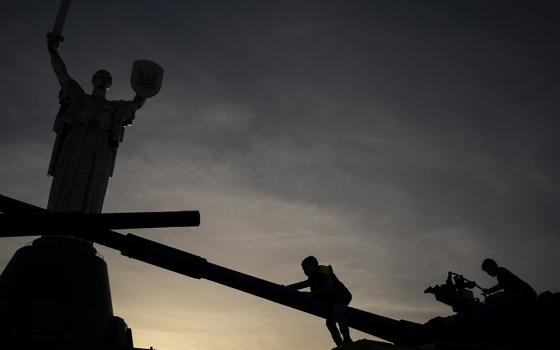 Children play on top of tanks on display in front of the Motherland Monument Oct. 31 in Kyiv, Ukraine. (AP photo/Bram Janssen)