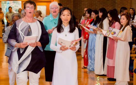 Cathy Buchanan, left, and Tram Bui make their first vows for the Dominican Sisters of Peace in 2023. 