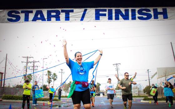 Daughter of Charity Sr. Elizabeth Sjobert crosses the finish line at the Sisters on the Run marathon on Jan. 28, 2023. She founded Sisters on the Run, which raises money for Proyecto Juan Diego, a mission serving low-income Hispanic families in Brownsville, Texas. 