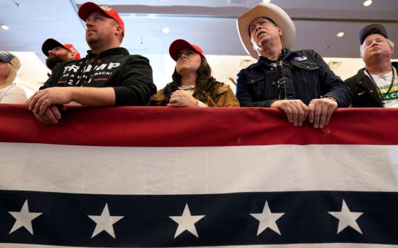 Audience members listen to former President Donald Trump speak during a commit to caucus rally on Dec. 13 in Coralville, Iowa. (AP/Charlie Neibergall, file)