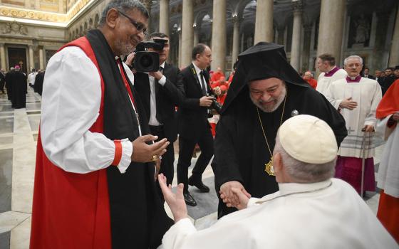 Pope Francis meets Anglican Archbishop Ian Ernest, the archbishop of Canterbury's representative in Rome, and Orthodox Metropolitan Polykarpos of Italy, the Ecumenical Patriarchate's representative in Rome, during an ecumenical evening prayer service marking the end of the Week of Prayer for Christian Unity at the Basilica of St. Paul Outside the Walls in Rome Jan. 25. (CNS/Vatican Media)