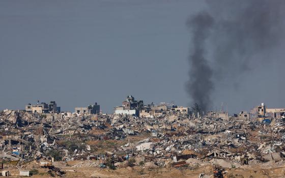 Smoke rises over Gaza as seen from Israel Jan. 16, 2024, amid the ongoing conflict between Israel and the Palestinian Islamist group Hamas. Violence and attacks have spread throughout the Middle East region, including Iran's launch of ballistic missiles late Jan. 15, 2024, on neighborhoods of Irbil, the capital of Iraqi Kurdistan, which has left the Iraqi Catholic community feeling unsettled. (OSV News/Reuters/Amir Cohen)