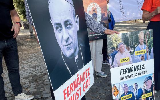 People hold posters with anti-Fernández messages, such as "Fernández must go"