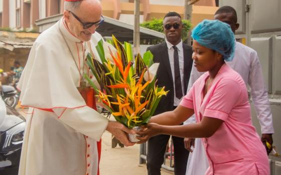 Cardinal Michael Czerny, prefect of the Dicastery for Promoting Integral Human Development, is greeted at the Saint Jean nonprofit health center in Cotonou, Benin, during his trip to the West African nation Jan. 17-20, 2024. During his visit to the health center Jan. 18, Cardinal Czerny met with the staff who provide much needed medical services for the people of the tiny African country neighboring Nigeria on the east, Togo and Burkina Faso on the west. (OSV News photo/courtesy Dicastery for Promoting Inte