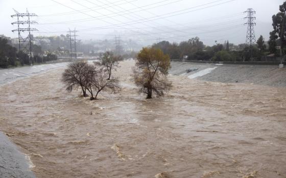 The Los Angeles River in Studio City, Calif., Feb. 5, 2024, is pictured during heavy rains. One of the wettest storms in Southern California history unleashed at least 475 mudslides in the Los Angeles area after dumping more than half the amount of rainfall the city typically gets in a season in just two days, and officials warned Feb. 6 that the threat was not over yet. (OSV News photo/Aude Guerrucci, Reuters)