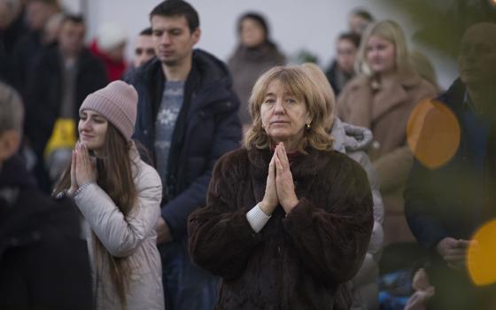 Worshippers pray the blessing of water on the Dnipro River after Major Archbishop Sviatoslav Shevchuk, head of the Ukrainian Greek Catholic Church, celebrated a Divine Liturgy Jan. 6, 2024, at the Patriarchal Cathedral of the Resurrection of Christ in Kyiv amid ongoing Russian aggression in Ukraine. (OSV News/Courtesy of Ukrainian Greek Catholic Church)