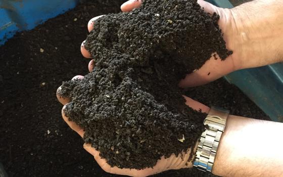 An undated file photo shows a person holding compost in a garden. (OSV News/Courtesy of University of Dayton)