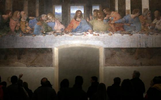 Visitors are pictured in a file photo looking at Leonardo da Vinci's "The Last Supper" on a refectory wall at Santa Maria delle Grazie Church in Milan. (OSV News/Reuters/Stefano Rellandini)