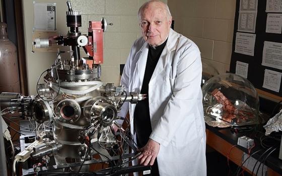 Portrait of Jesuit Fr. Frank Haig in laboratory. 