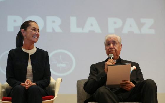 Presidential candidate Claudia Sheinbaum of Mexico's ruling party smiles as Archbishop Rogelio Cabrera López of Monterrey speaks March 11, 2024, during an event in Mexico City to sign a peace commitment organized by members of the Catholic Church.