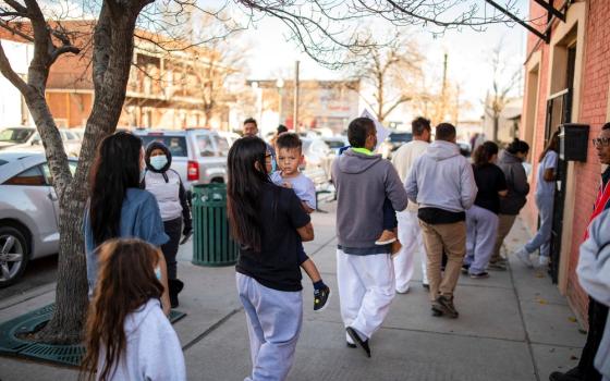 A family of migrants is dropped off by a transport contractor for the U.S. Customs and Border Protection at a shelter run by Annunciation House in downtown El Paso, Texas, Dec. 13, 2022.