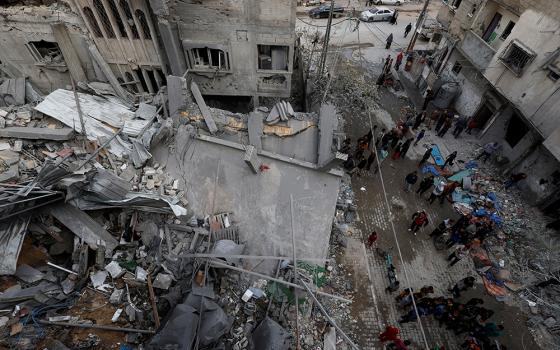  Palestinians inspect the site of Israeli airstrike on a house, amid the ongoing conflict between Israel and the Palestinian Islamist group Hamas, in Rafah, in the southern Gaza Strip, on March 24. (OSV News/Reuters/Mohammed Salem)