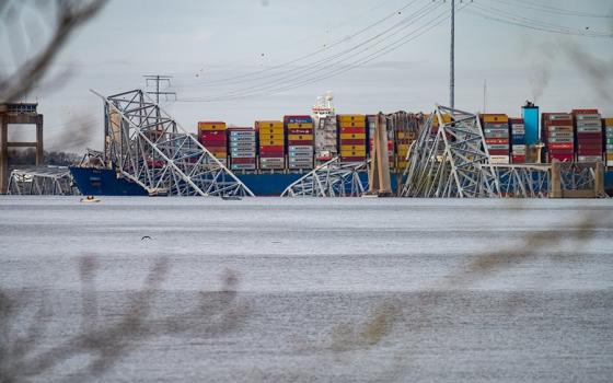 A section of the Francis Scott Key Bridge in Baltimore is seen collapsed into the Patapsco River March 26, following a main support column being struck in the early morning hours by the container ship Dali as it was leaving the Port of Baltimore. (OSV News/Catholic Review/Kevin J. Parks)