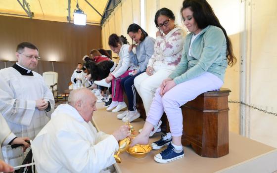 Pope Francis washes the feet of an inmate at the Rebibbia women's prison on the outskirts of Rome as he celebrates the Holy Thursday Mass of the Lord's Supper March 28, 2024. The pontiff washed the feet of 12 inmates at the prison. (CNS photo/Vatican Media)