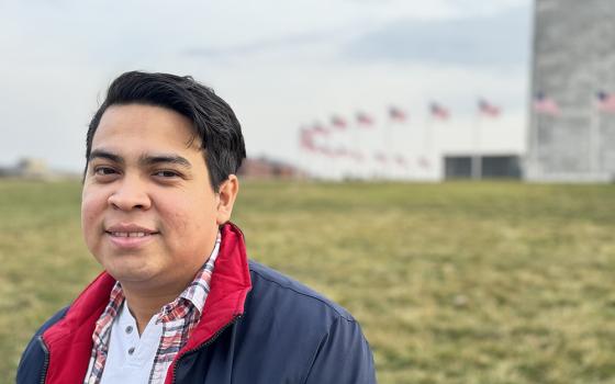 Miguel Flores, one of the 222 Nicaraguan political prisoners sent on a plane to Washington last year, poses for a photo near the Washington Monument on Feb. 22. He said he is determined to keep fighting for democracy and "can't look the other way" when it comes to the abuses in Nicaragua. (NCR photo/Rhina Guidos) 