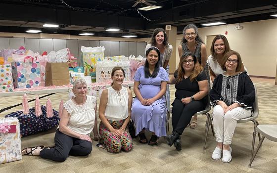 Members of Walking with Moms in Need groups, from Queen of the Rosary Parish in Overland Park, Kansas, and Church of the Nativity in Leawood, Kansas, throw a baby shower for an expecting mom. (Courtesy of Katie O’Hara)